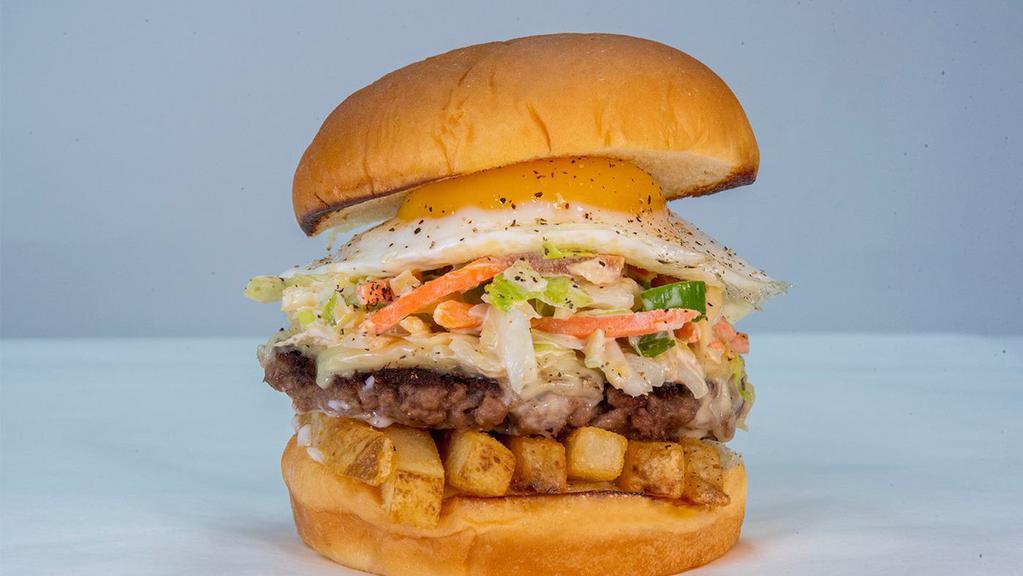 Slaw Burger · impossible patty, white American cheese, fries, haus slaw, fried egg, mayo.