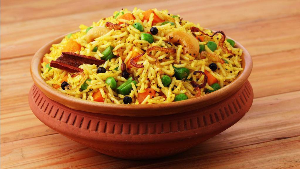 Veg. Biryani · Classic South Indian preparation made of long grain basmati rice, mixed vegetables & traditional spices cooked under dum - served with veg kurma & raitha.