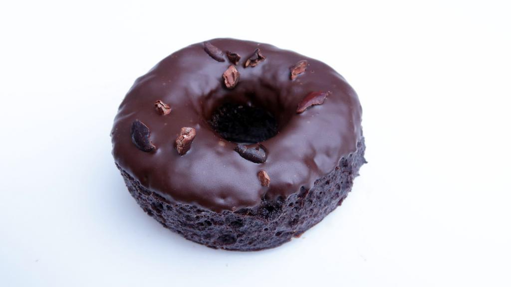 Chocolate Star Anise · Chocolate base glazed with chocolate, star anise, and sprinkle of cacao nibs.