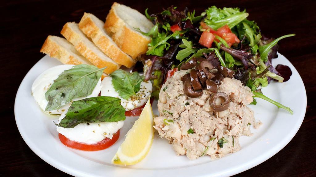 South Beach Salad · Mixed greens, tuna, green onion, tomatoes, fresh mozzarella, basil, olives, and virgin olive oil. Served with bread.