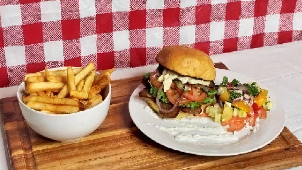Gyro Burger Meal · 5oz mediterranean seasoned lamb beef gyro on a toasted bun topped with green leaf, tomatoes, cucumbers, onions, feta cheese & tzatziki sauce served french fries