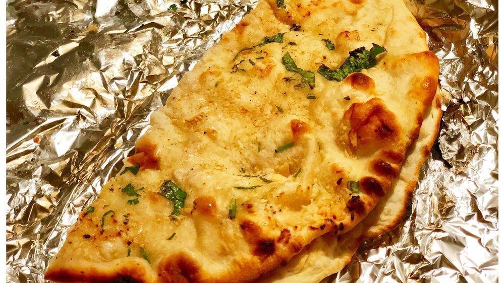 Garlic  Naan · Vegetarian. Naan garnished with fresh garlic, cilantro & herbs.