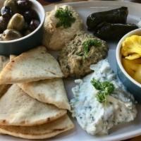 Mezze Plate · Muhammara, mutabal, tzatziki, dolmas, olives, feta and Moroccan pickled vegetables served wi...