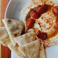 Hummus · House-made hummus with smoked paprika and oven-roasted cherry tomatoes served with pita.