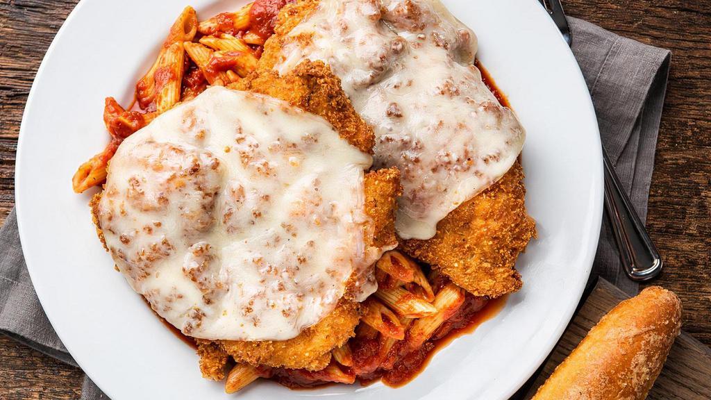 Chicken Parmesan · Pounded chicken covered with seasoned breadcrumbs and fried to perfection. We top two portions of chicken with premium melted provolone and place over a bed of penne smothered in marinara. Includes one breadstick.