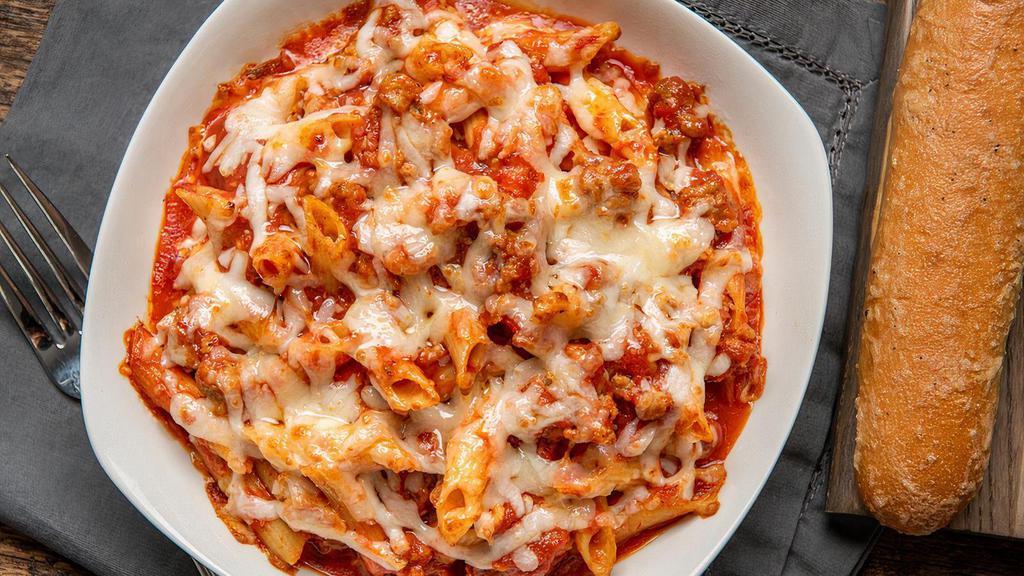 Baked Penne · Nonna's go-to meal is penne smothered in an Italian sausage marinara sauce and just enough garlic butter. Topped with shredded mozzarella. Includes one breadstick.
