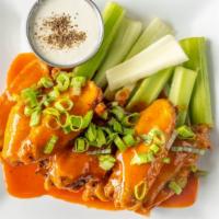 Crispy Chicken Wings · Gluten free. Tossed in house buffalo sauce, celery and blue cheese dressing.