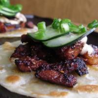 Korean Pork Tacos · don pisto's housemade flour tortillas, chili yogurt, cucumber