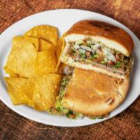 Torta · Your choice of meat, beans, tomatoes, onions, cilantro and guacamole on a French roll of bre...