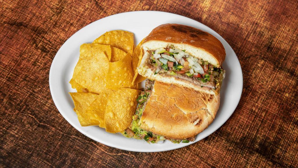 Torta · Your choice of meat, beans, tomatoes, onions, cilantro and guacamole on a French roll of bread.
