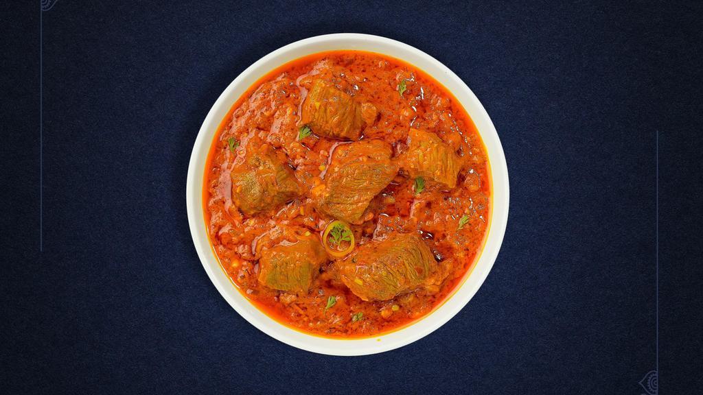Lamb Of The Curry · Bone-in lamb cooked in a tomato based onion gravy with freshly ground spices.