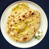 Paneer Paradise Naan · Freshly baked bread stuffed with minced paneer cooked in a clay oven.