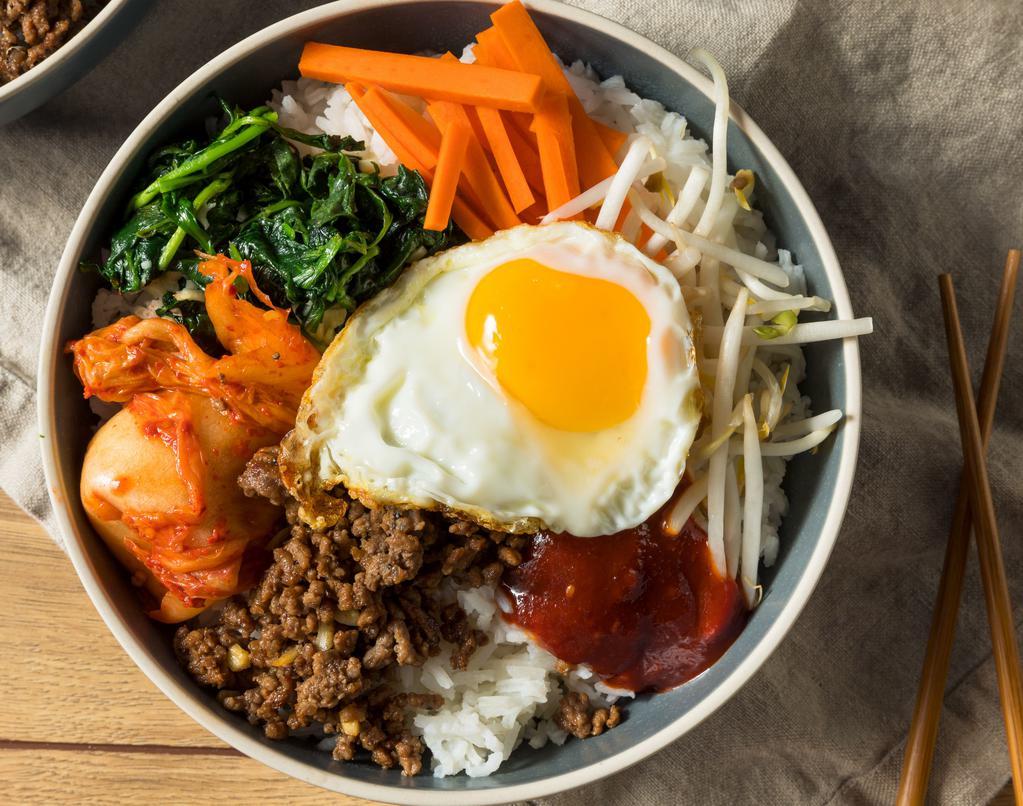 Bibimbap · Bean sprout, carrot, mushroom, and other vegetables served over rice. Topped with a fried egg and sliced beef. Mixed rice bowls.