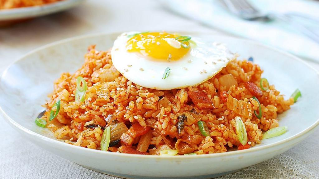 Kimchi Fried Rice · Kimchi, vegetable and choice of Pork, beef, or seafood fried rice with Korean spicy source, and a fried egg on top.