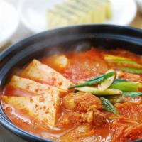 Kimchi Stew · Vegetarian and spicy. Kimchi stew with tofu, onion,  and sliced kimchi.