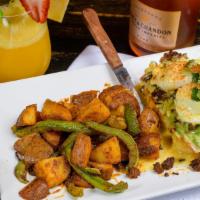 Mexican Eggs Benedict · Avocado, chorizo, grilled onions, two poached eggs, hollandaise sauce topping, served over s...