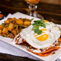 Chilaquiles (Rojos) · Corn tortilla chips tossed in choice of salsa, chorizo, sour cream , quest fresco and pico d...