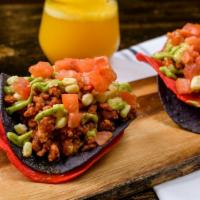 Vegan Tostada (2) · Crispy tortilla, refried beans, Soy-rizo, pico de gallo, corn and avocado sauce