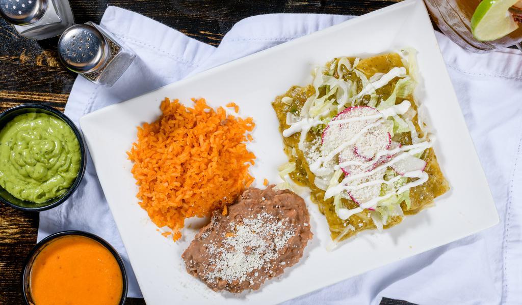 Enchiladas Verdes (3) · Filled with Pollo en tinga rolled in a corn tortilla, melted Jack cheese, topped with lettuce, cotija cheese, sour cream, and radishes. Served with rice and beans
