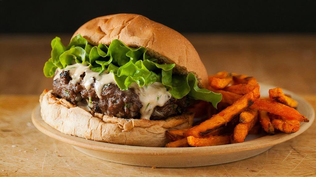 Lamb Gourmet Burger · 1/3-pound minced lamb patty, grilled and served with roasted peppers, onions, tomato, lettuce, and fried onion strings.