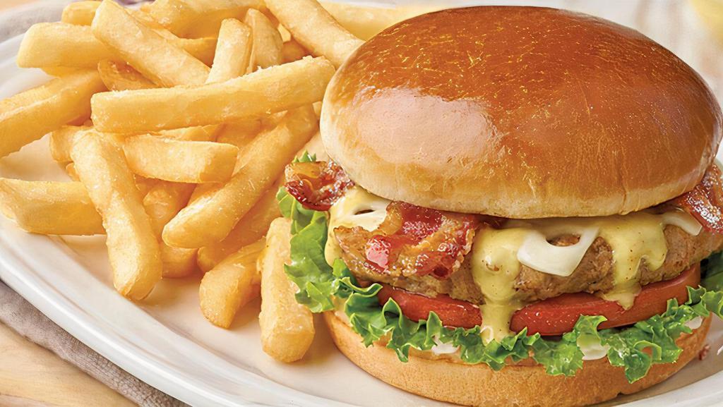 Turkey  Burger · Premium tukey patty charbroiled in low heat served with roasted peppers, lettuce, tomato, fried onion strings and chipotle aioli sauce