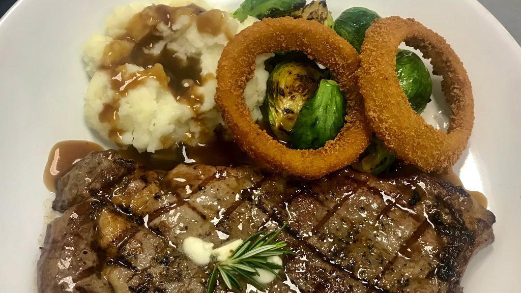 Pan Seared Butter-Basted Steak · Juicy, crips Rib-eye steak (12oz) cooked in a cast iron skillet with garlic butter and fresh rosemary.  Served with mashed potatoes, grilled sprouts and steak sauce.