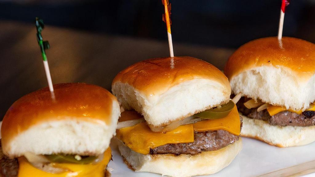 Slider Trio · Lamb or beef Angus patty charbroiled in low heat. Served with American cheese, grilled onion, and sliced jalapenos.