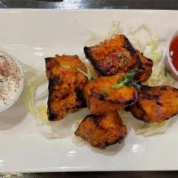 Tikka Kebab (Appetizer) · Marinated meat chunks, skewered, and charbroiled over an open flame. Served on top of fresh ...