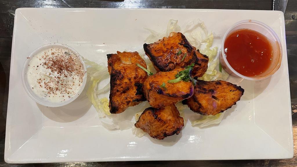 Tikka Kebab (Appetizer) · Marinated meat chunks, skewered, and charbroiled over an open flame. Served on top of fresh cut lettuce.