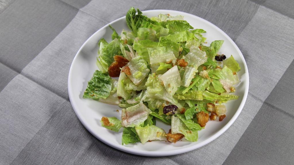 Caesar Salad · Green salad of Romaine lettuce and croutons dressed with lemon juice, olive oil, and parmesan cheese. Whisk smooth and creamy Caesar dressing.