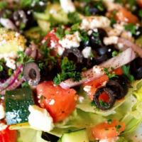 Greek Salad · Green salad of Romaine lettuce, red onion, olives, bell peppers, tomatoes, cucumber, and Fet...