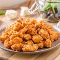Crispy Popcorn Chicken · Delicious popcorn chicken served with basil and five spices.