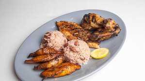 Jerk Chicken & Salmon · Served w/ Rice and Beans & Fried Plantains