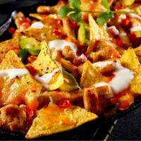 Mas Nachos with Carne Asada · Hot & Crispy Mexican-style chips topped with perfectly seasoned shredded steak, and a genero...