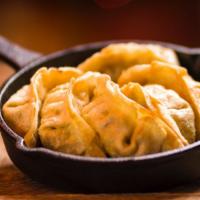Deep Fried Gyoza  (8 Pcs.) · Crispy fried dumplings with pork filling served with a savory sauce.
