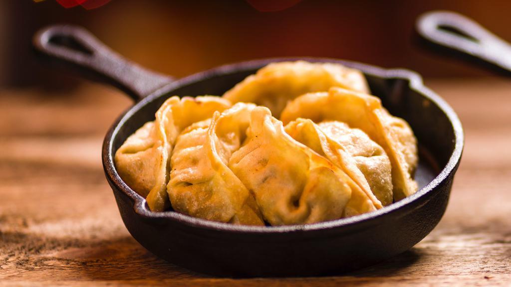 Deep Fried Gyoza  (8 Pcs.) · Crispy fried dumplings with pork filling served with a savory sauce.
