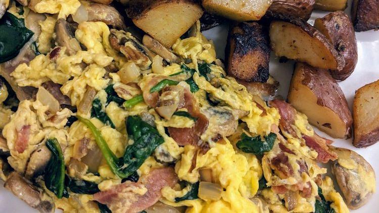 Village Scramble · Three egg scramble with bell peppers, mushrooms, avocado, spinach, and Jack cheese with homefries.