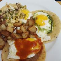 Three Amigos · Three corn tortillas topped with refried beans, sunny side up eggs, salsa rojo, and pico de ...