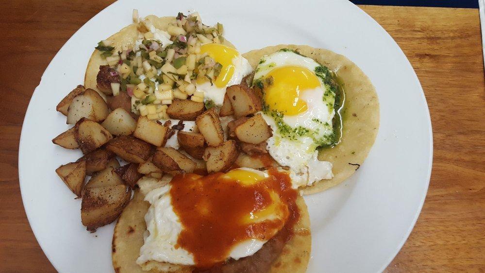 Three Amigos · Three corn tortillas topped with refried beans, sunny side up eggs, salsa rojo, and pico de gallo