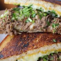 Birria Grilled Cheez · Two perfectly toasted sourdough bread slices stuffed with our delicious beef birria, 3 chees...