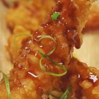 Shrimp Tempura · Deep-fried shrimp drizzled with guacsalsa sauce.