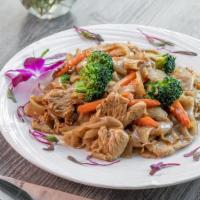 PAD SEE EW CHICKEN  · Thick rice noodle stir fry with egg, broccoli, carrot, chicken, and sweet black soybean sauce.
