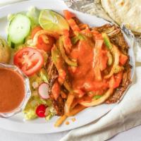 BISTEC SALVADOREÑO · salvadorean beefsteak cooked with tomato sauce and onion