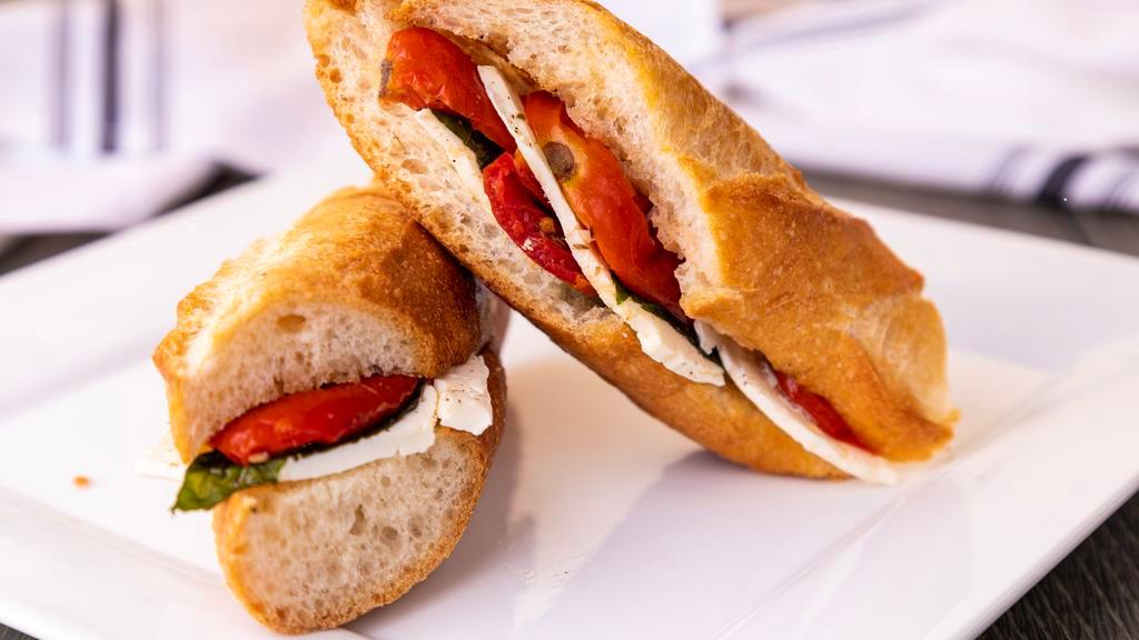 Caprese Baguette · Sweet baguette with fresh mozzarella slices, fresh basil, fire roasted tomatoes, and salt & pepper