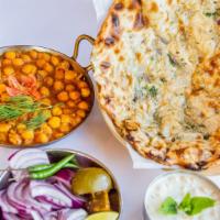 Amritsari Kulcha Chole · Flaky traditional layered ﬂat bread served with spiced chick peas.
