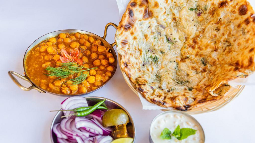Amritsari Kulcha Chole · Flaky traditional layered ﬂat bread served with spiced chick peas.