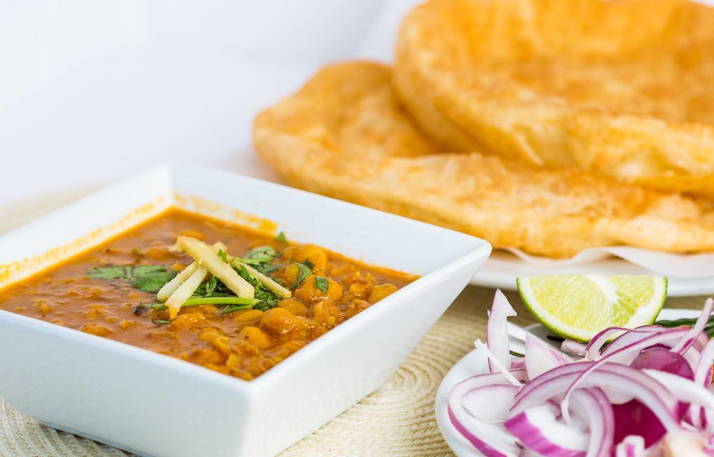 Chana Bhatura · Puffed leanvened bread served with garbanzo beans cooked in special peshawari style gravy.