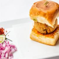 Bombay Vada Pav · Spiced potato patty sandwiched between two slices of pav served with chutneys.