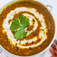 Dal Makhani (Dhabewali Kali Dal) · A harmonious combination of mixed lentil, tomato, ginger, garlic and house spices.