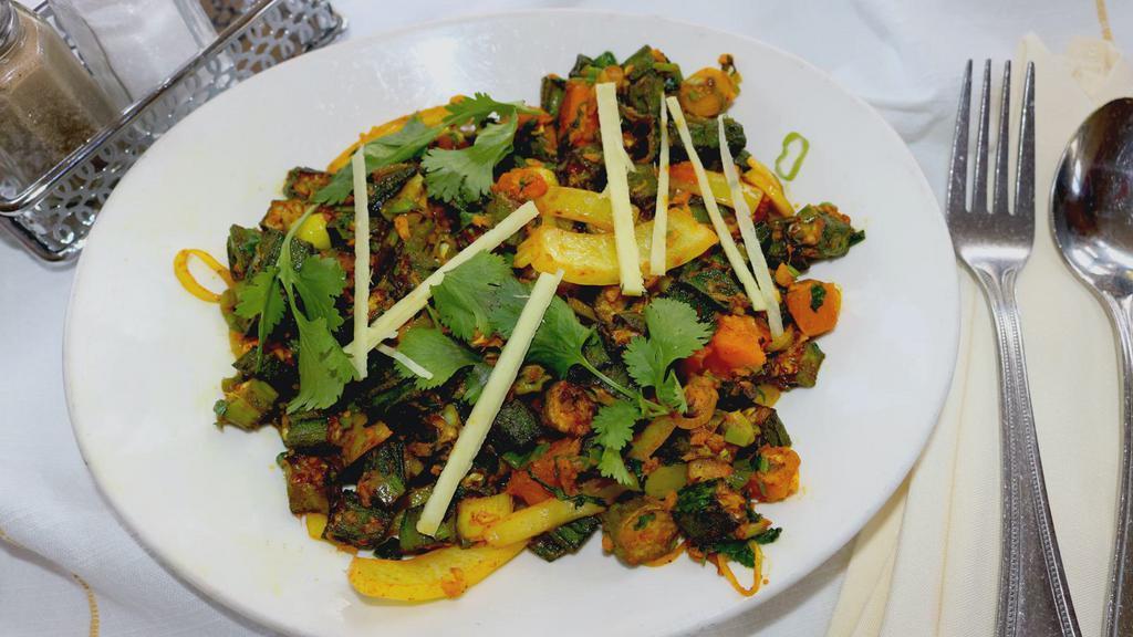 Jaipuri Masala Bhindi · Fresh cut okra cooked with onion, tomatoes, ginger, garlic and herbs.